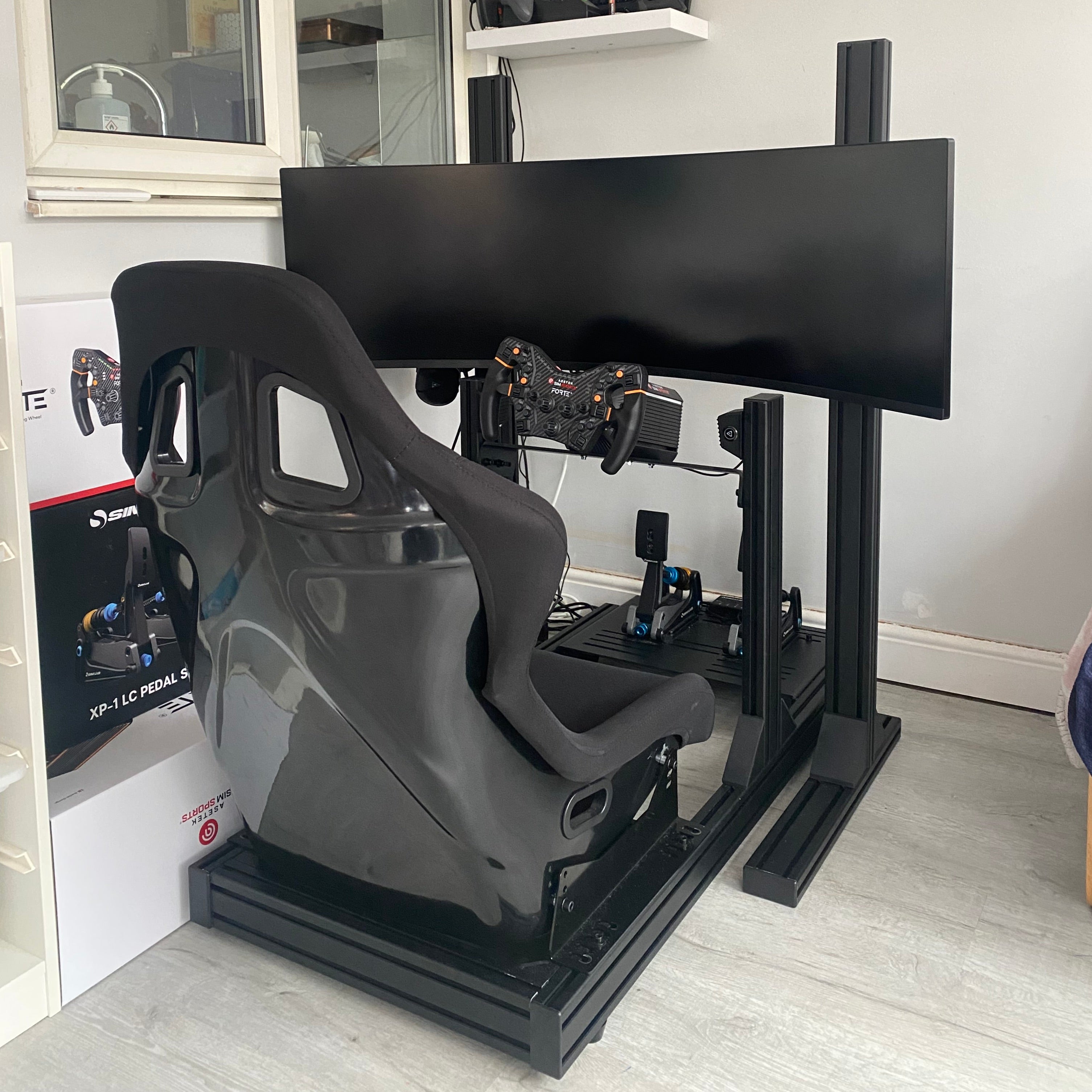 R-PRO Black Edition 80x40 Sim Rig, GTS Bucket Seat, Asetek Forte 18Nm Wheelbase, Asetek Forte Formula Steering Wheel, Sim-Lab XP1 Pedals, R-Single Monitor Stand, Samsung Odyssey G9 Ultrawide Monitor